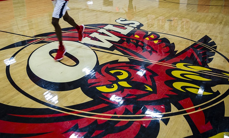 An Ooltewah basketball player runs across the school logo at center court during basketball practice at Ooltewah High School on Tuesday, Dec. 20, 2016, in Ooltewah, Tenn. One year after former players on the team sexually assaulted a teammate during an overnight trip to Gatlinburg, the program is rebuilding.