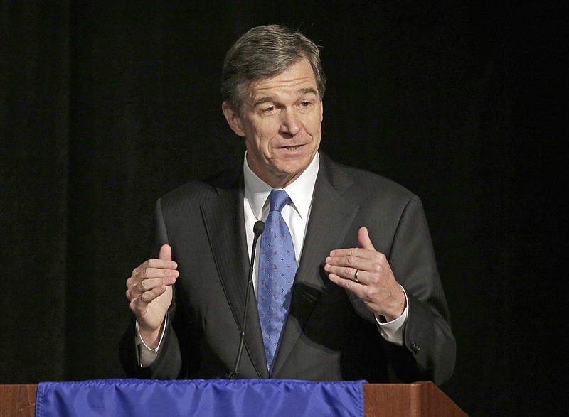  In this June 24, 2016, file photo, North Carolina Attorney General Roy Cooper speaks during a forum in Charlotte, N.C. Cooper, North Carolina's next Democratic governor, has vowed to keep his campaign promises to bend back the rightward course of the state. But with only a 10,000-vote victory over GOP Gov. Pat McCrory and bitter partisan distrust in this deeply divided state, he's already slipped along the rocky path he must walk to work successfully with the legislature. And Republicans will maintain veto-proof majorities in 2017. (AP Photo/Chuck Burton, File)