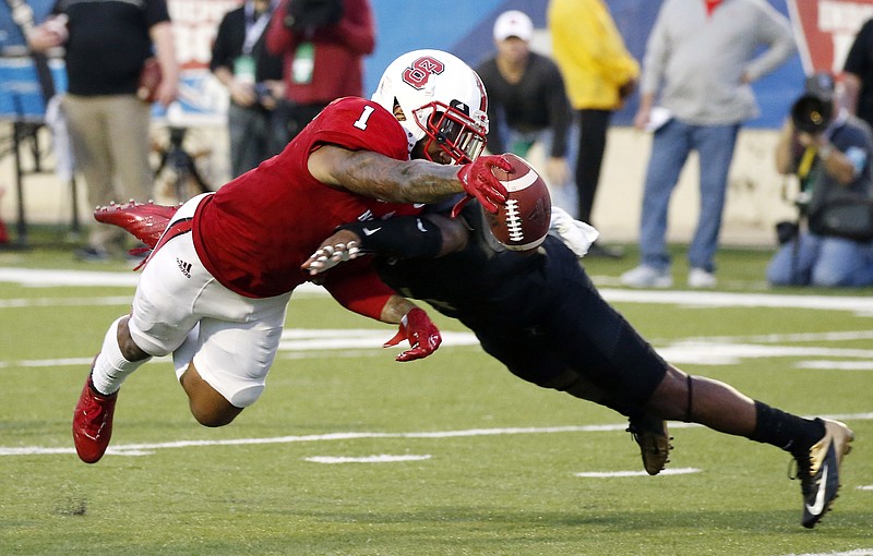 North Carolina State tight end Jaylen Samuels (1) dives into the end zone past a Vanderbilt defender for a first-half touchdown in the Camping World Independence Bowl NCAA college football game in Shreveport, La., Monday, Dec. 26, 2016. (AP Photo/Rogelio V. Solis)