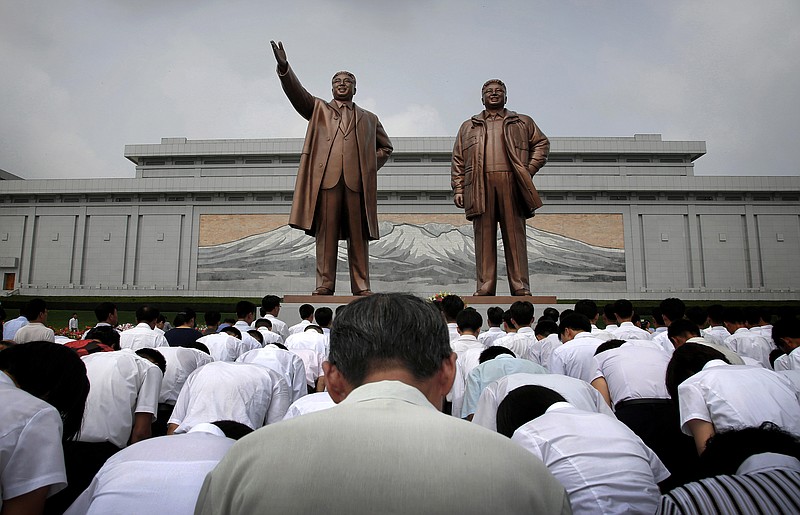 
              FILE - In this July 27, 2015, file photo, North Koreans bow in front of bronze statues of the late leaders Kim Il Sung, left, and Kim Jong Il at Munsu Hill in Pyongyang, North Korea. These two bronze statues were created by artists from Mansudae Art Studio. The studio was created in 1959 by Kim Il Sung. It has generated an estimated 38,000 statues and 170,000 other monuments for domestic use and, according to the website of its overseas representative office, it is divided in 13 creative groups, seven manufacturing plants and has more than 50 supply departments. (AP Photo/Wong Maye-E, File)
            