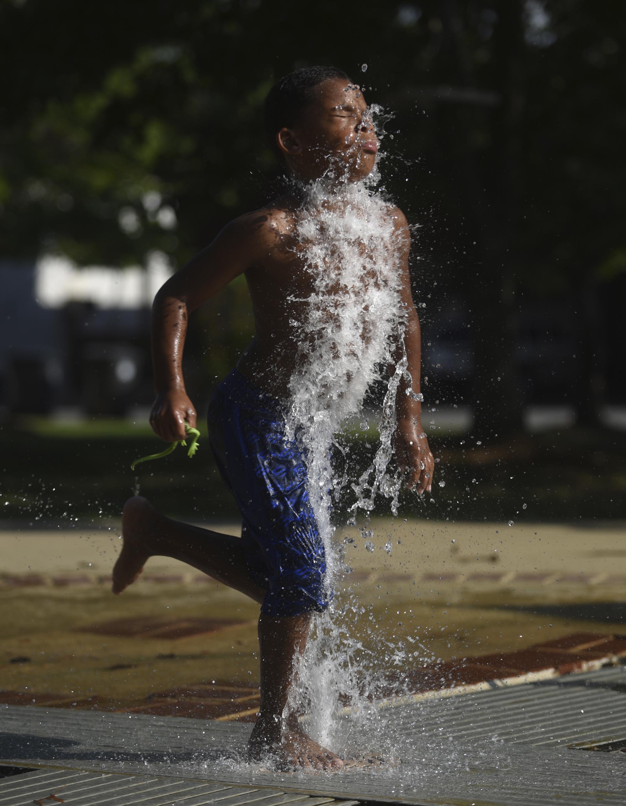 Bryson Penson runs through the water Wednesday, August 31, 2016 at Joe Stock Memorial Park.