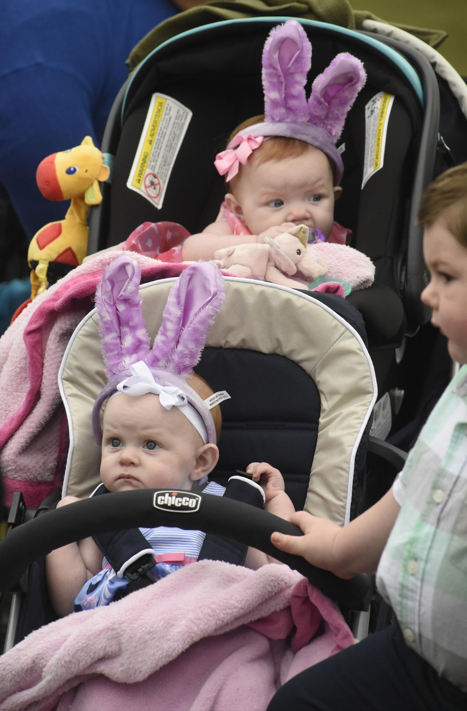 Twin 8-month-old sisters Hadley Thurman, front, and Hazel Thurman wait with their brother Mason Thurman, age 4, during the Easter at Coolidge event on Sunday, Mar. 27, 2016, in Chattanooga, Tenn.