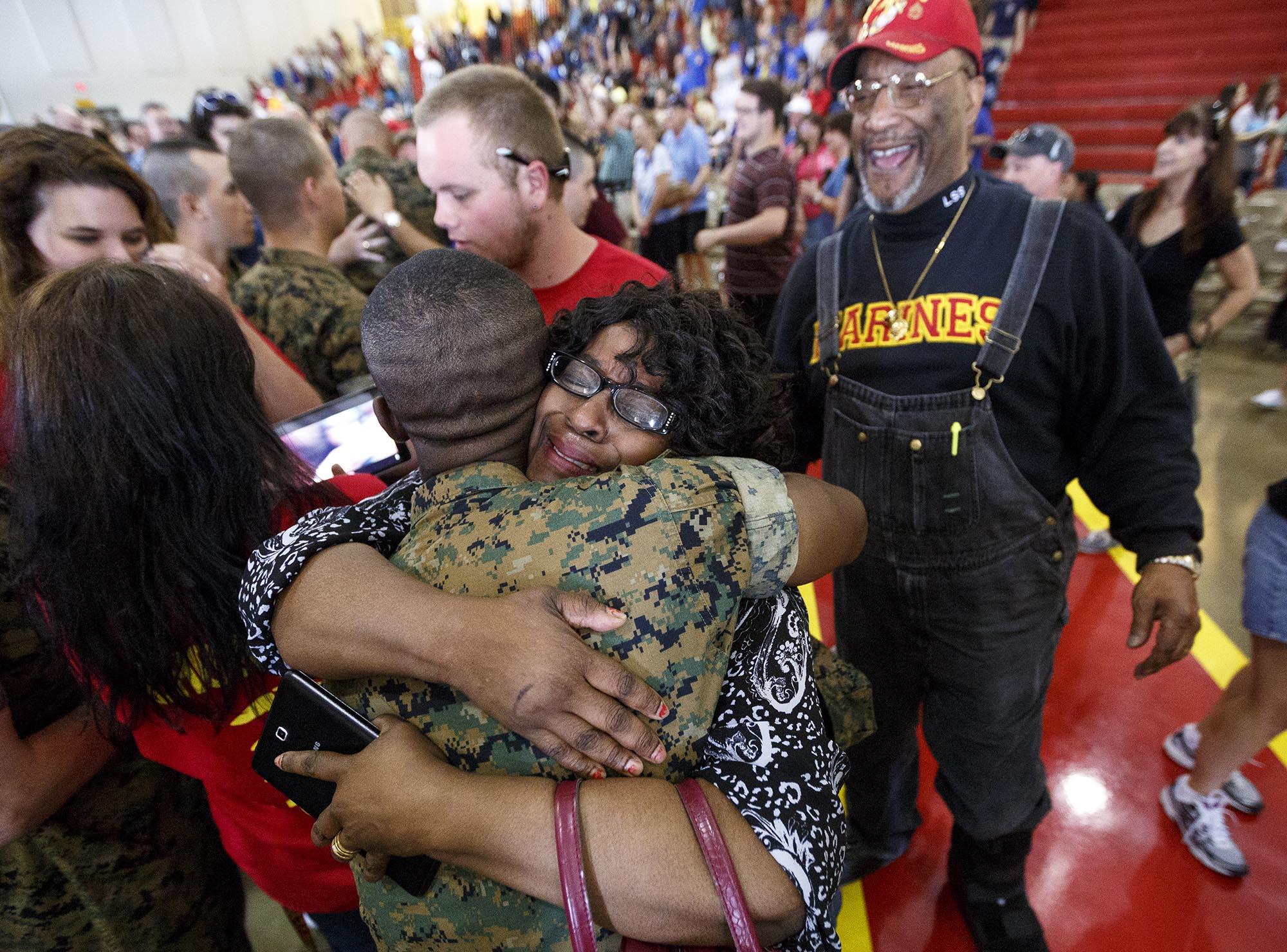 Sherlene Lucas, from Washington, D.C., hugs her son Pvt. Alexander Lucas, a new Marine, upon seeing him for the first time since his departure for boot camp 13 weeks ago at the Marine Corps Recruit Depot on Thursday, April 28, 2016, in Parris Island, South Carolina. The new Marines were released to spend time with their families for family day on the day before their graduation ceremony.