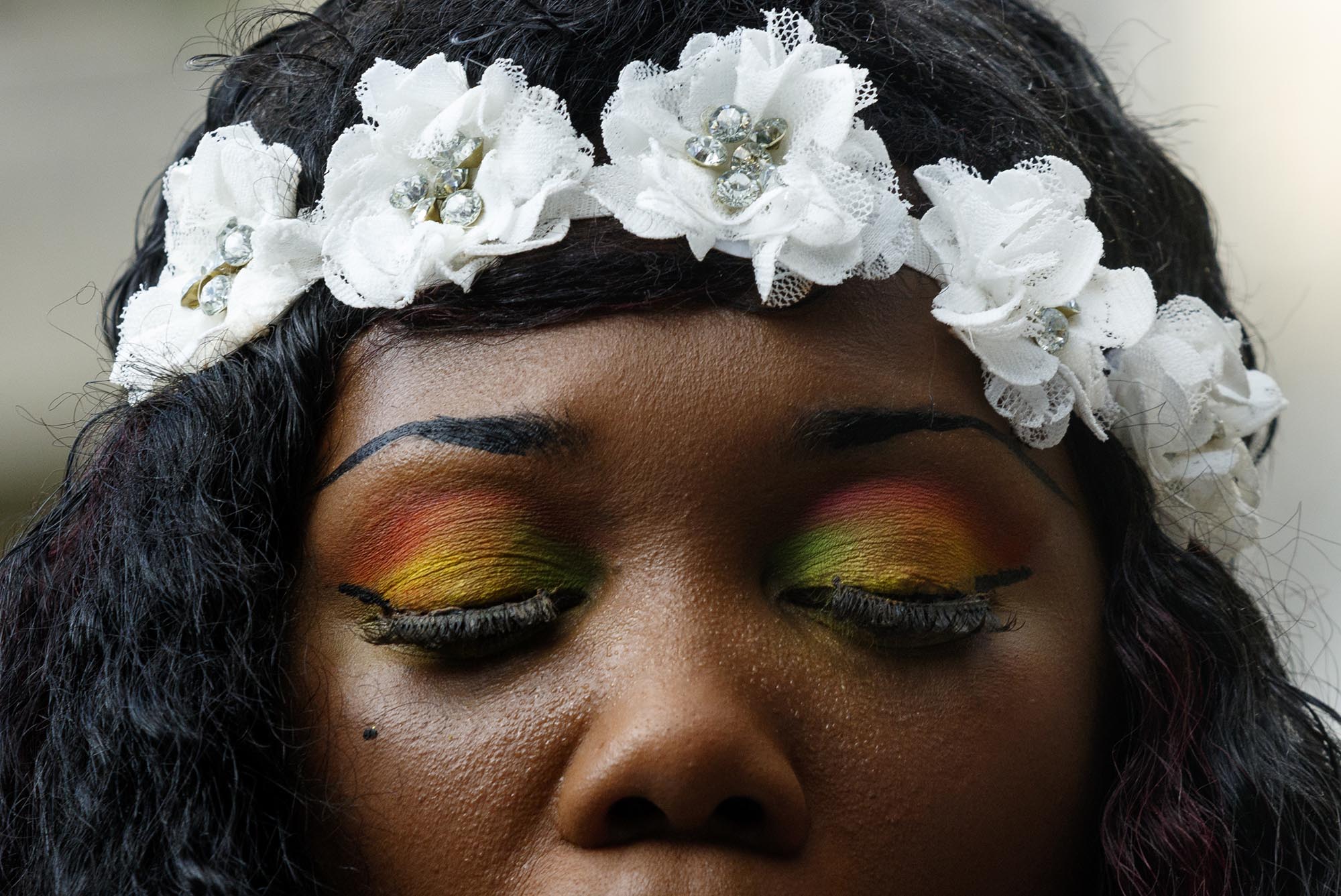 Pastor Charlotte Williams wears rainbow eyeshadow as she speaks during a Black Lives Matter protest in Miller Park on Thursday, July 21, 2016, in Chattanooga, Tenn. Protesters marched from Miller Park to the Tennessee Aquarium and back, stopping and blocking numerous intersections along the route.