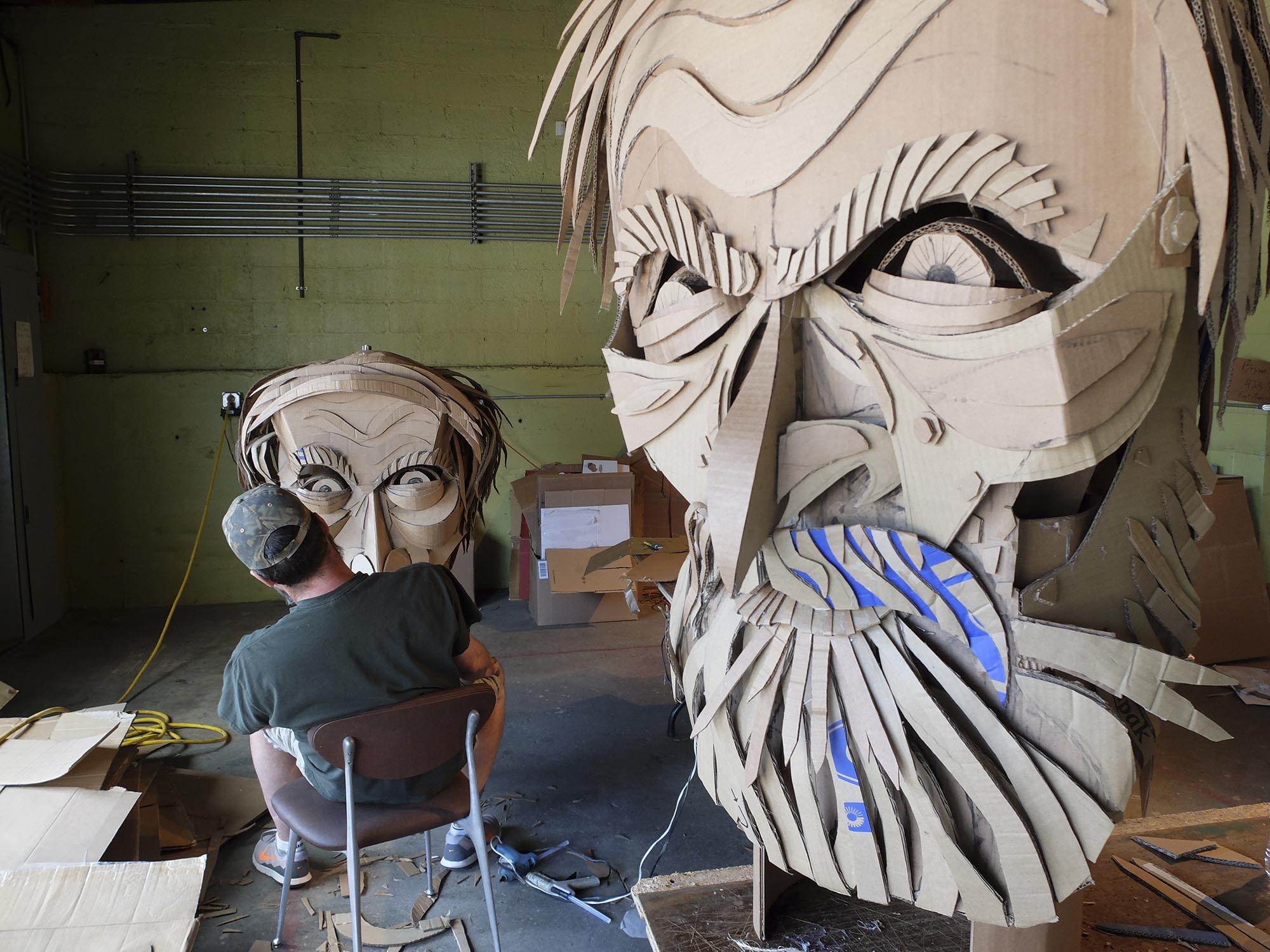 Artist Wayne White, left, works on the cardboard face of Confederate General Patrick Cleburne for Saturday's Glass Street LIVE parade. The oversize puppets, fifteen-feet-tall, will be used to commemorate the Centennial of the National Park Service. The event is brought to you by the Shaking Ray Levi Society.