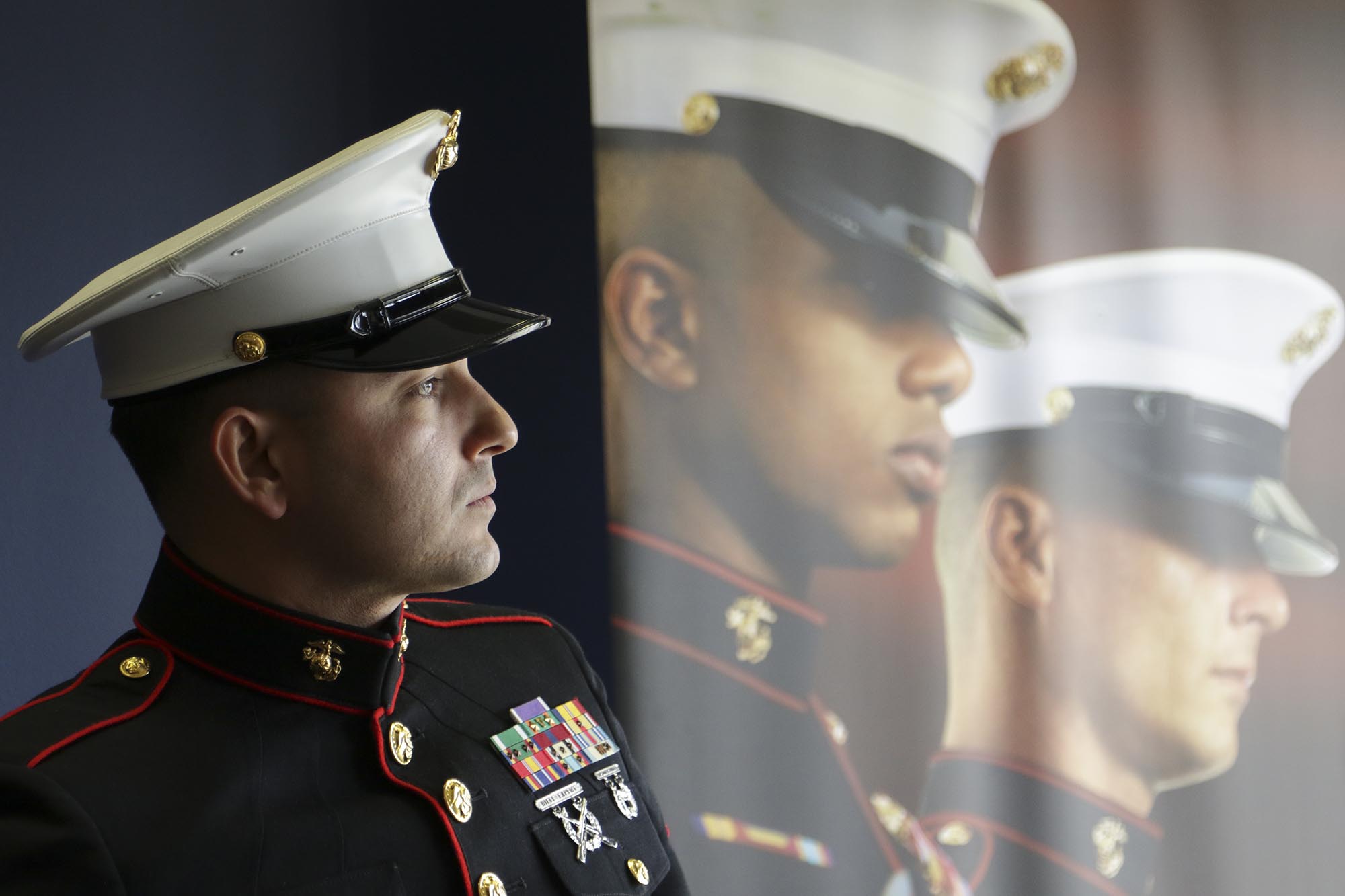 Staff Photo by Dan Henry / The Chattanooga Times Free Press- 12/14/16. SSGT. Jeff Cantu looks out of the National Guard and Armed Forces Career Services Center window before participating in a wreath laying ceremonuy at the Lee Highway shooting memorial on Wednesday, Dec. 14, 2016. The wreaths were delivered by a police escort of Walmart tractor trailers where an intimate gathering of armed forces personnel and family members witnessed the event.