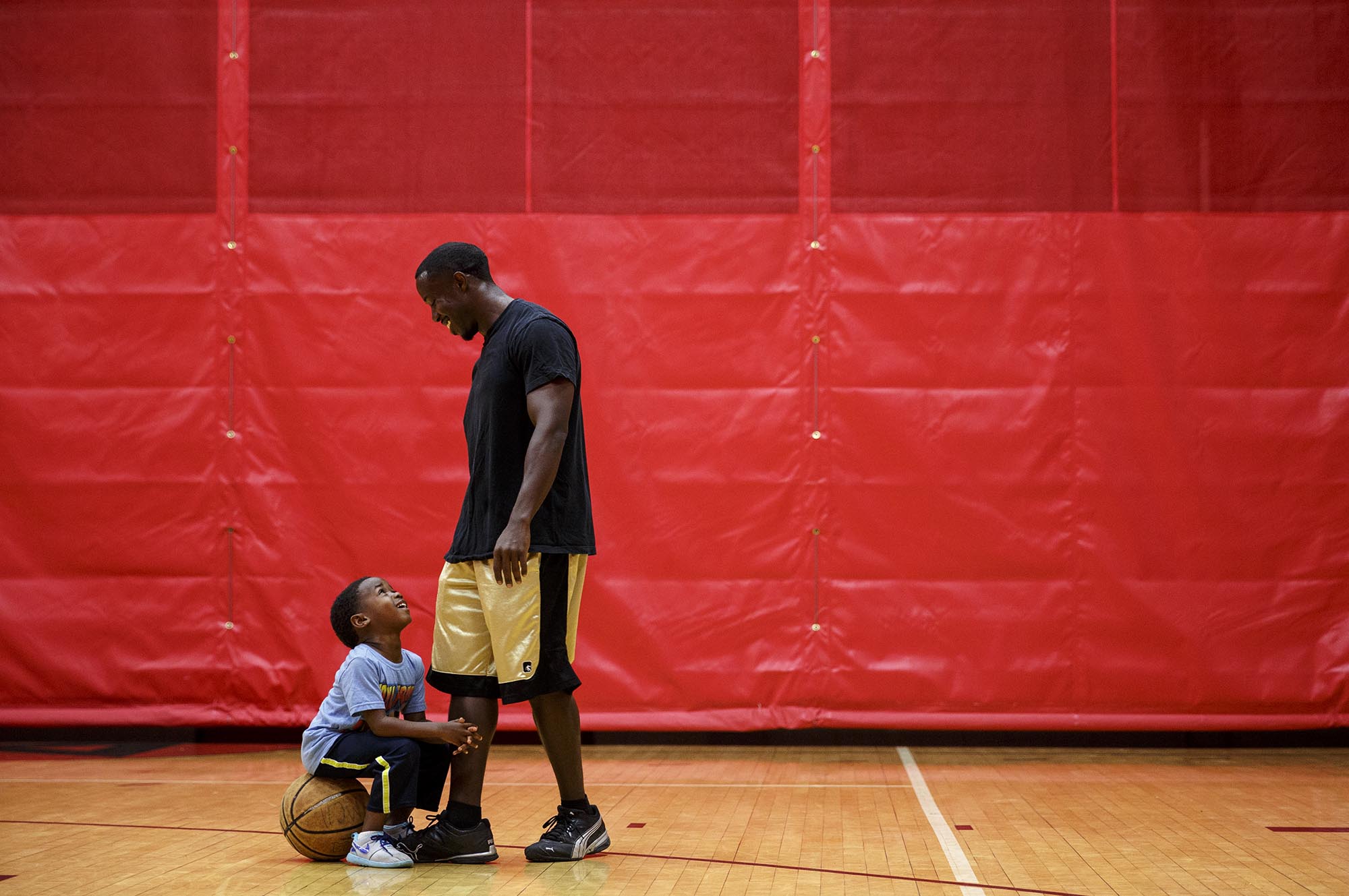 Tim plays basketball with Tariq at the YMCA across from their apartment building. Since his studio apartment is small, Tim tries to go out with his kids to keep them entertained.