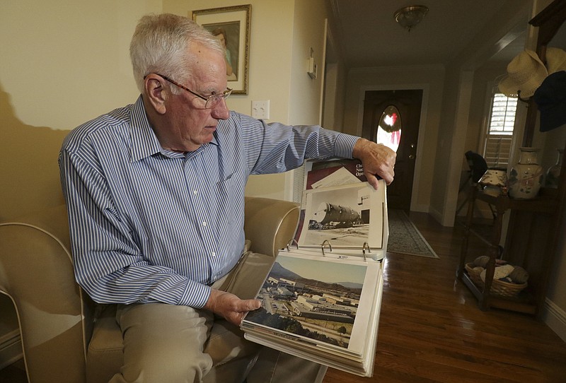 Staff Photo by Dan Henry / The Chattanooga Times Free Press- 12/27/16. Phil Chaffin looks through a scrapbook of memorabilia while at his Dunlap, Tenn., residence from when he worked at Combustion Engineering during its heyday. 