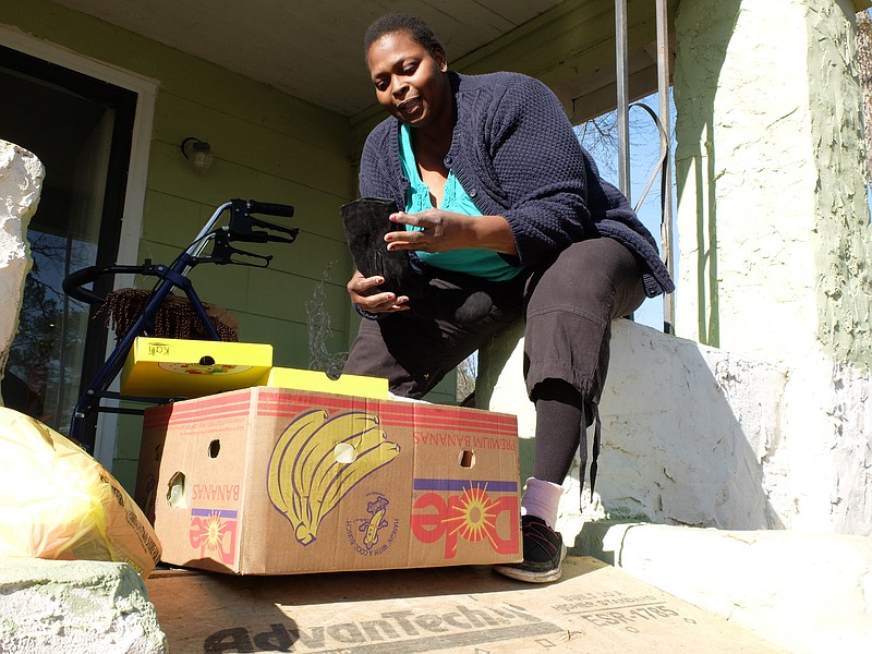 Sonya Burrell, 46, sits on her front porch Wednesday near Highway 58, where she recently received assistance for her electric bill.