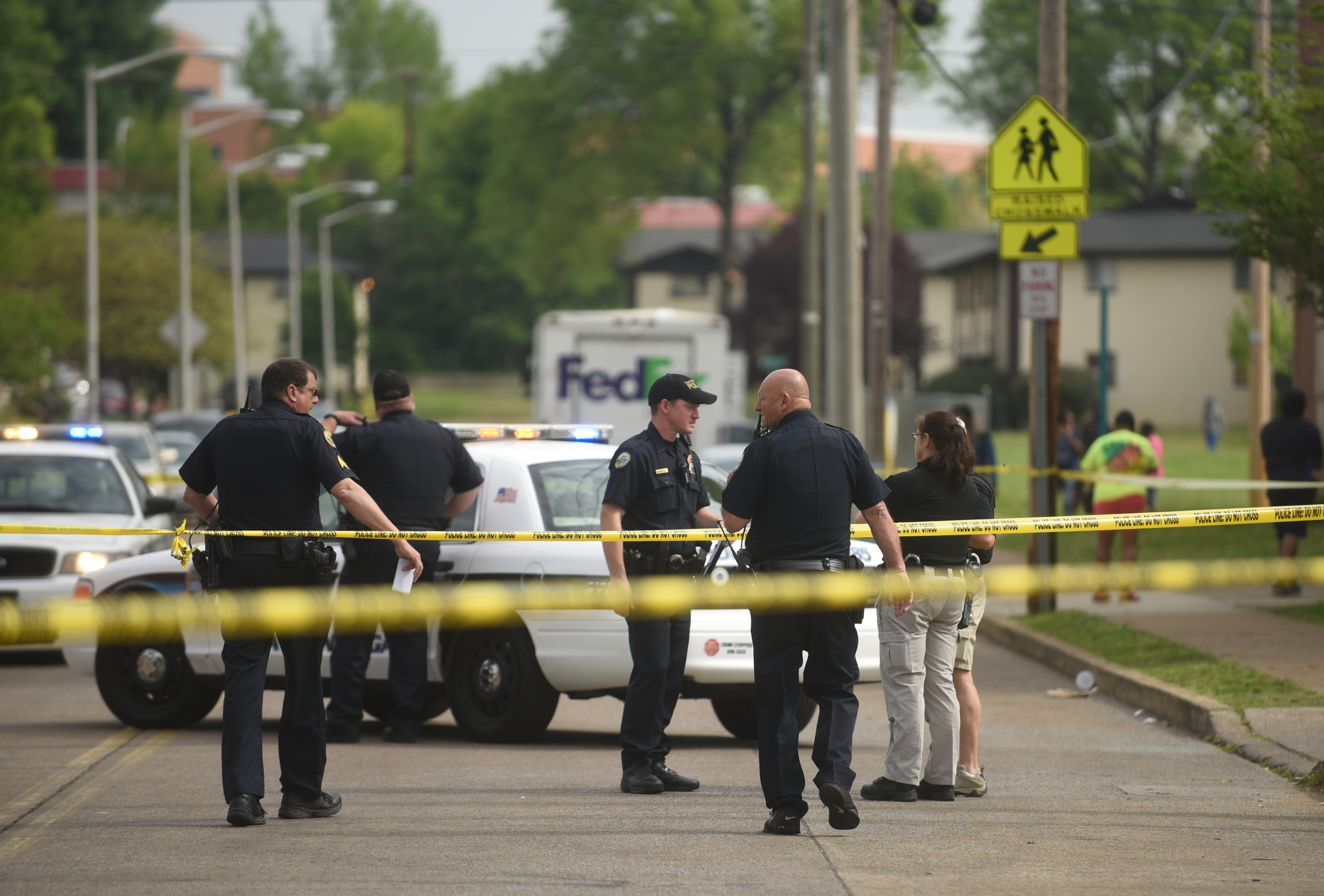 Officers work the scene of a shooting Tuesday, April 19, 2016 on Grove Street. A pregnant woman was shot in the abdomen and transported to the hospital.