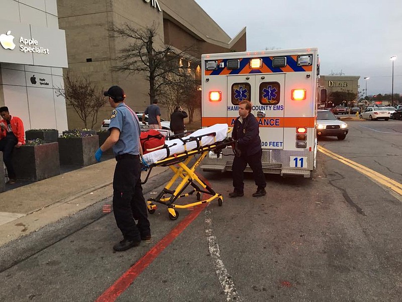 Emergency personnel prepare to aid people injured after fireworks were set off at Hamilton Place mall Monday.