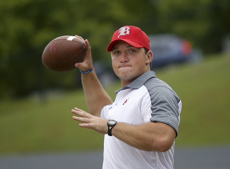 Baylor School assistant football coach Jacob Huesman helps with warmups before a game in August. Huesman, a former Baylor and UTC standout, has signed with the New York Giants' practice squad.