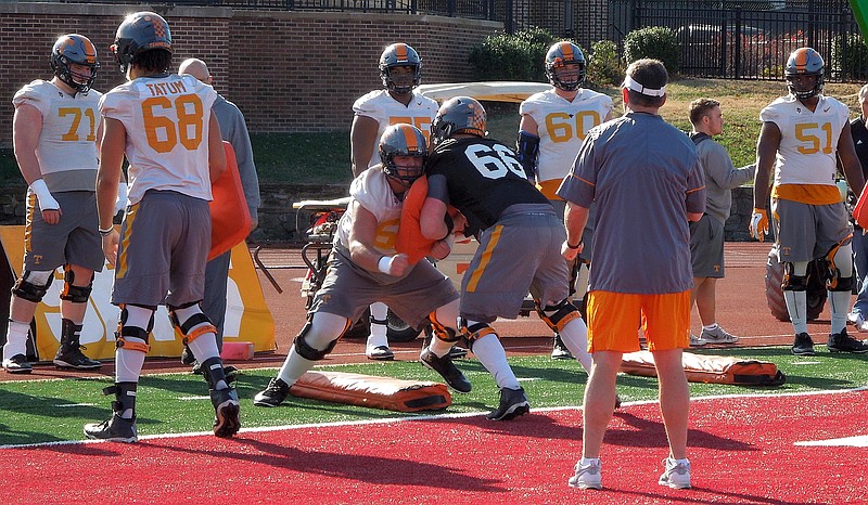 Offensive lineman Jack Jones (center) blocks during a drill during Tennessee's practice at Montgomery Bell Academy on Dec. 27 as the Vols continue to prepare to play Nebraska in Music City Bowl.