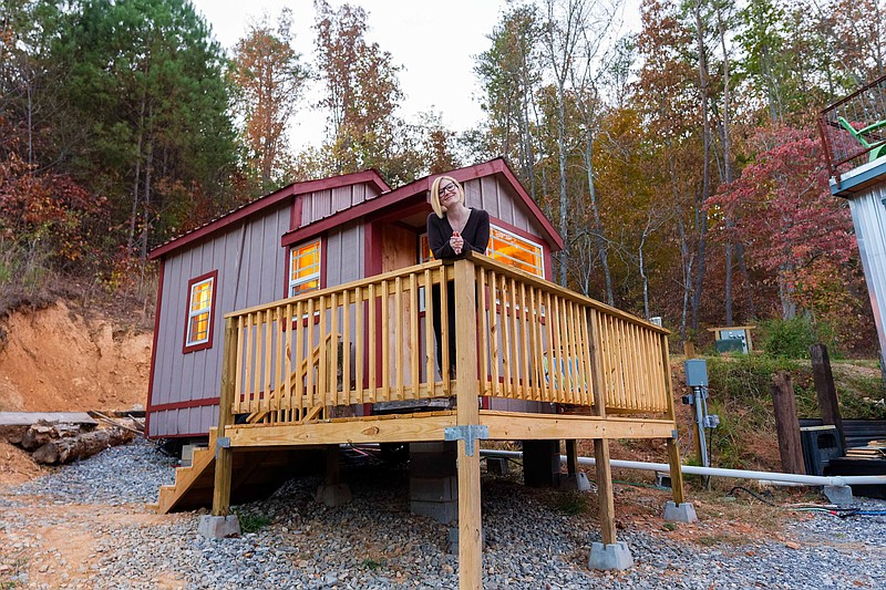 Author Sunny Montgomery on the porch of Live a Little Chatt's tiniest tiny home, the 126-square-foot "Wandering Gypsy." (Photo by Jennifer Woods)