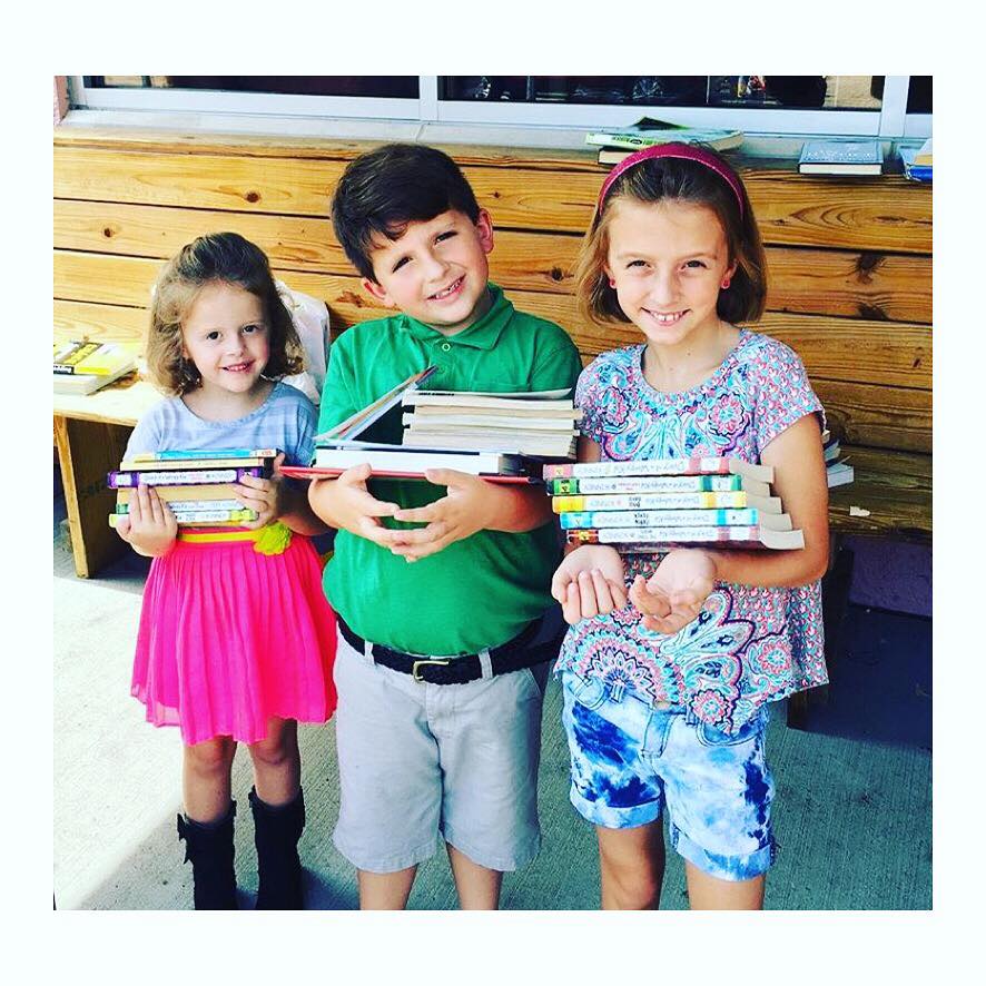 Local children bring books to donate to homebound.
