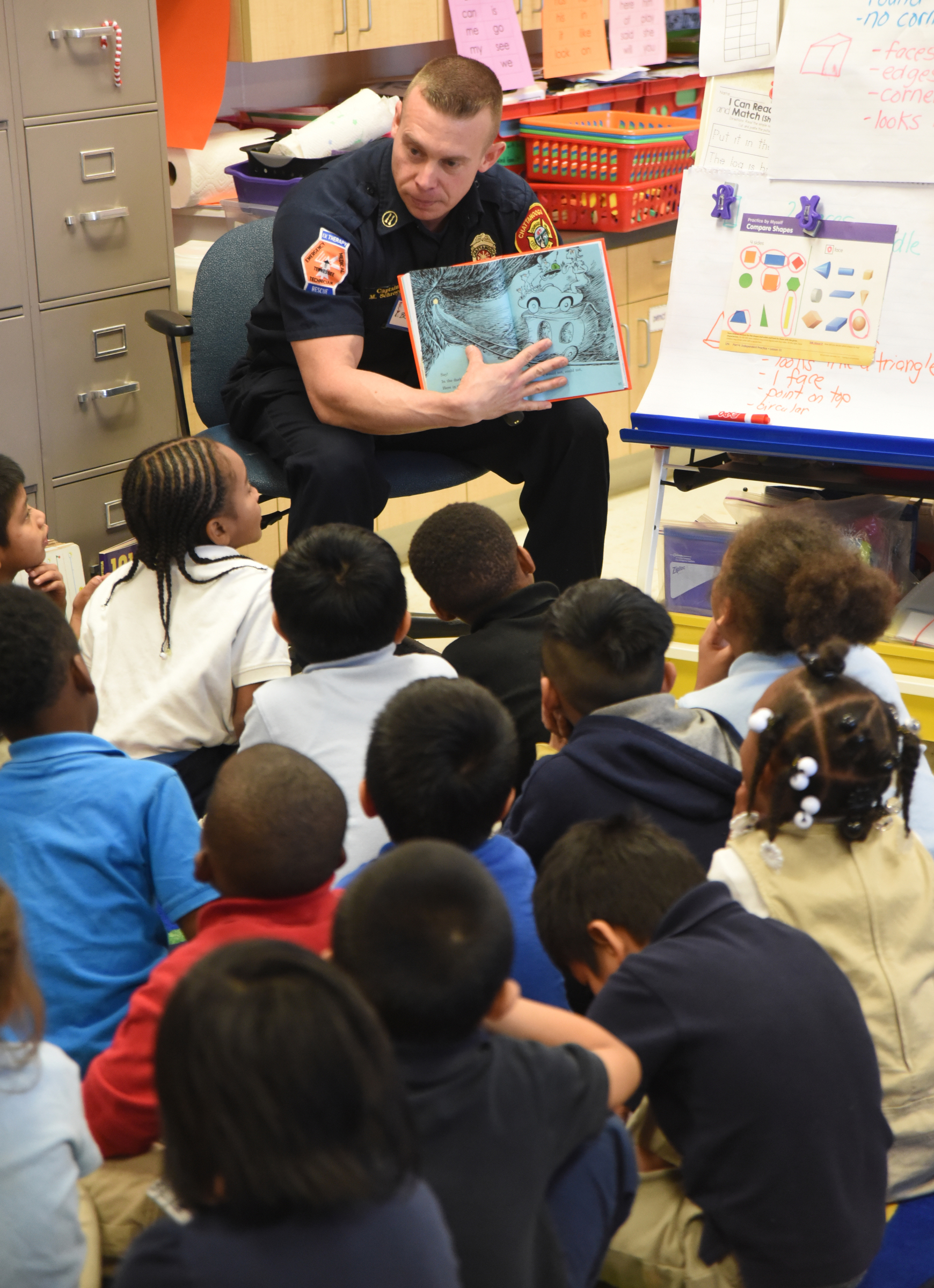 Capt. Brandon Schroyer, with the Chattanooga Fire Department, reads Dr. Seuss books to East Chattanooga Elementary kindergarteners as part of Read Across America week.