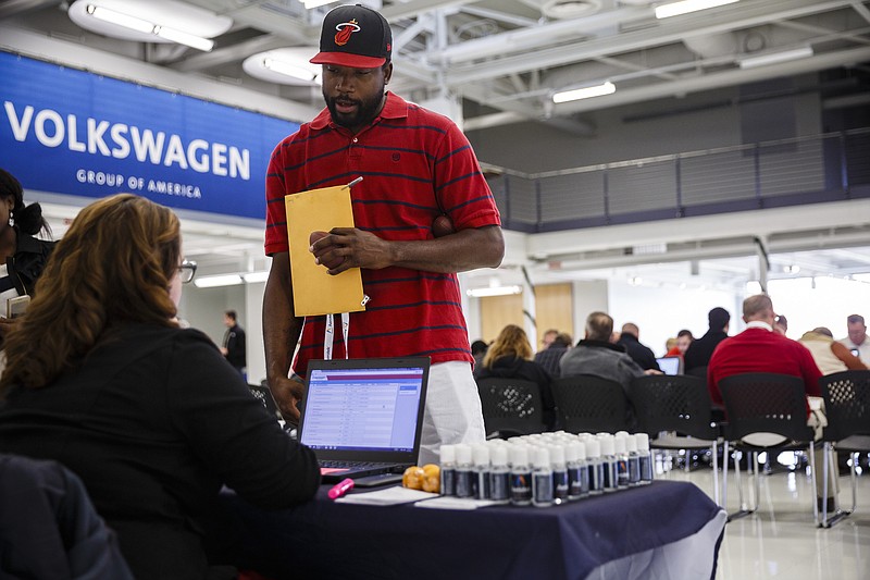 Jimmy Sills applies for a job during a job fair with Volkswagen staffing contractor Aerotek held at the Volkswagen Manufacturing Plant on Friday, Dec. 16, 2016, in Chattanooga, Tenn. Aerotek is hiring to fill production slots for manufacturing Volkswagen's new Atlas SUV.