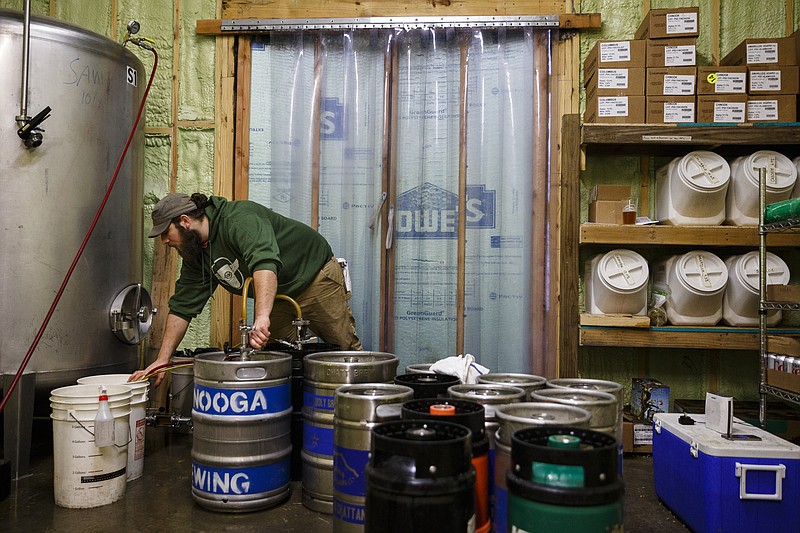 Jordan Gwin fills kegs for distribution at Chattanooga Brewing Company on Thursday, Dec. 29, 2016, in Chattanooga, Tenn. On Jan. 1, a new state law increases the alcohol by volume cap for beer from 6.2% to 10.1% which will allow grocery stores and breweries to sell high-gravity beers which could previously only be sold at liquor stores.