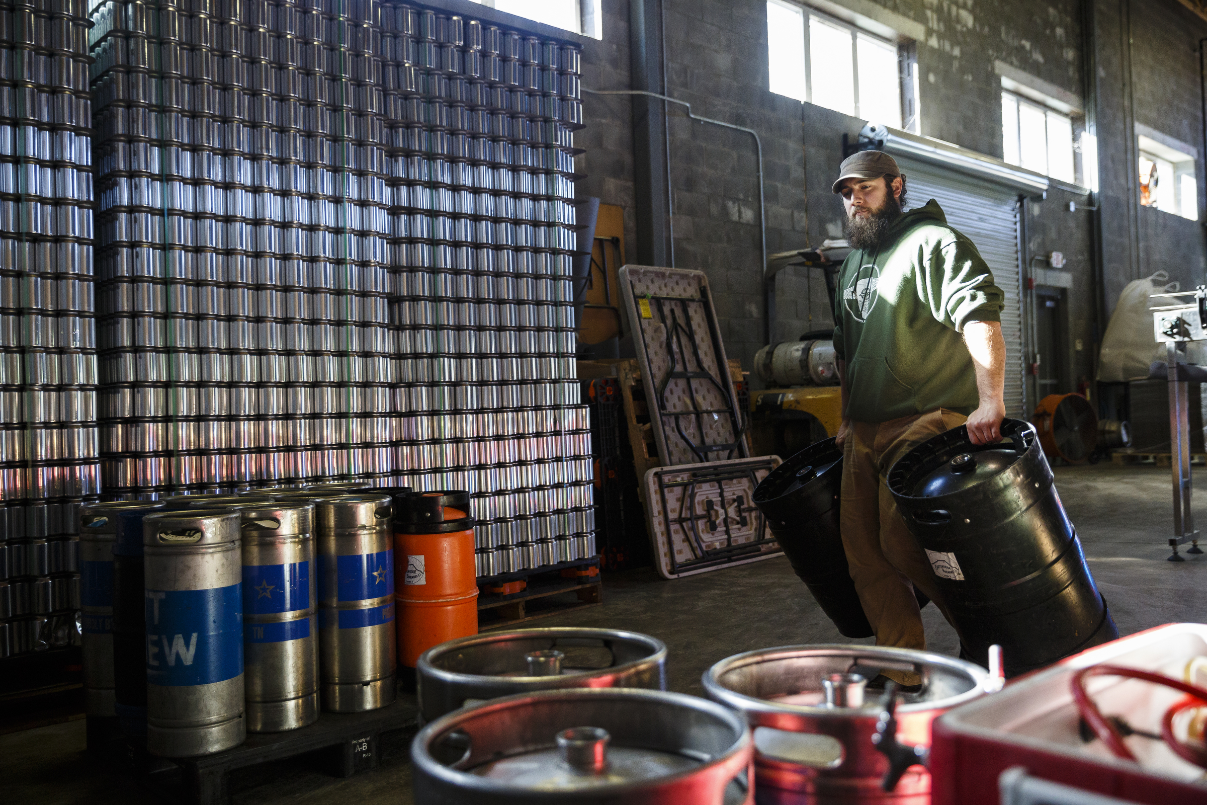 Jordan Gwin carries kegs to be filled for distribution at Chattanooga Brewing Company on Thursday, Dec. 29, 2016, in Chattanooga, Tenn. On Jan. 1, a new state law increases the alcohol by volume cap for beer from 6.2% to 10.1% which will allow grocery stores and breweries to sell high-gravity beers which could previously only be sold at liquor stores.