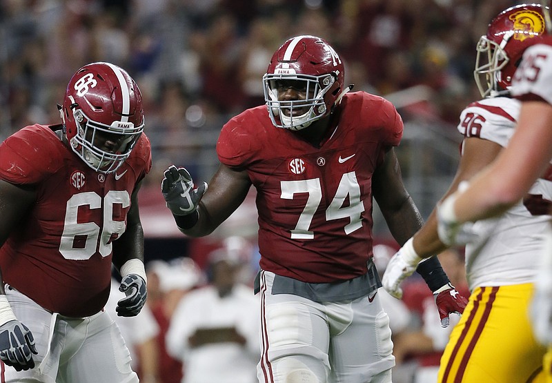 Alabama junior offensive tackle Cam Robinson (74), shown with fellow lineman Lester Cotton (66) during the season opener against Southern California.