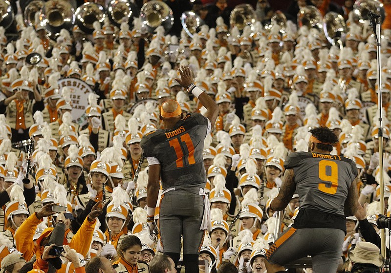 Tennessee quarterback Joshua Dobbs (11) and defensive end Derek Barnett (9) cheer after leading the band at the close of their Music City Bowl victory against the Nebraska Cornhuskers at Nissan Stadium on Friday, Dec. 30, 2016, in Nashville, Tenn. Tennessee won 38-24.
