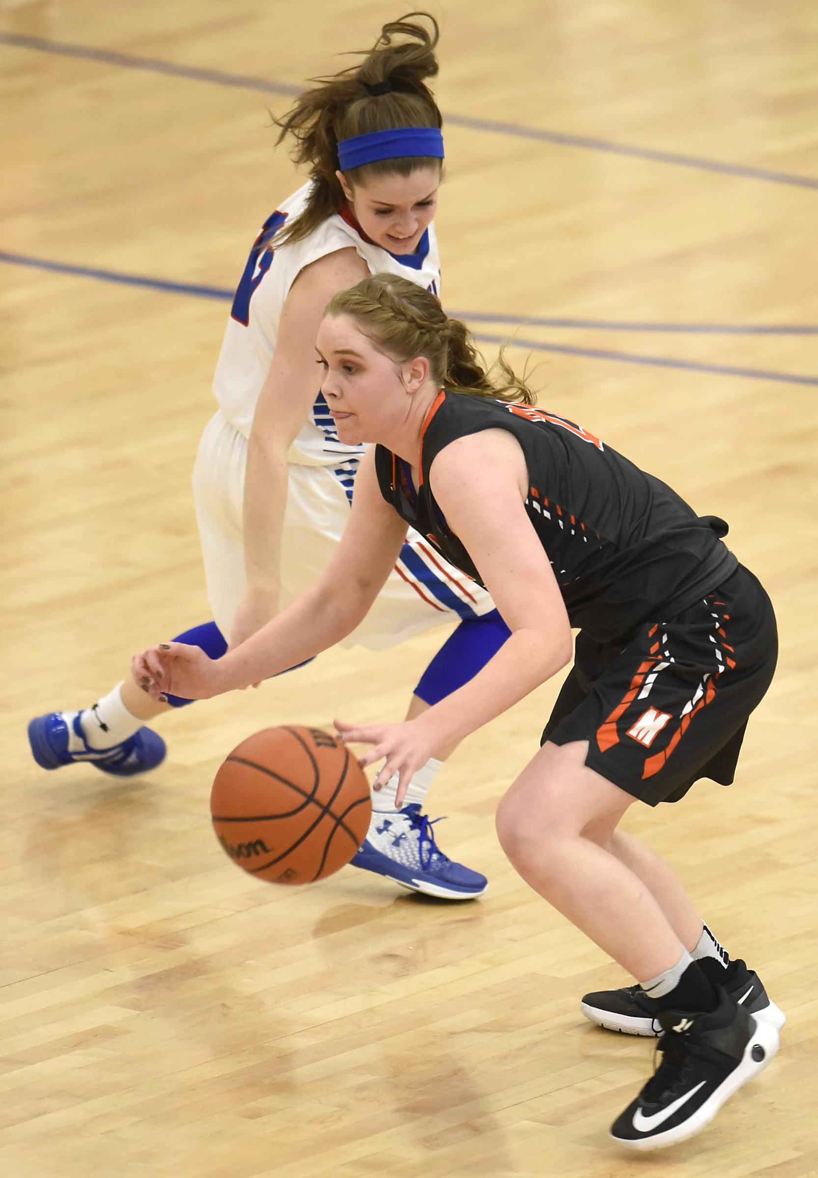 Meigs County's Kaylie Moore (21) steals the ball from Cleveland's Braylee Franklin (11). The Meigs County Lady Tigers visited the Cleveland Lady Raiders in TSSAA girls basketball action during the Cleveland Holiday Tournament held on Friday December 30, 2016.