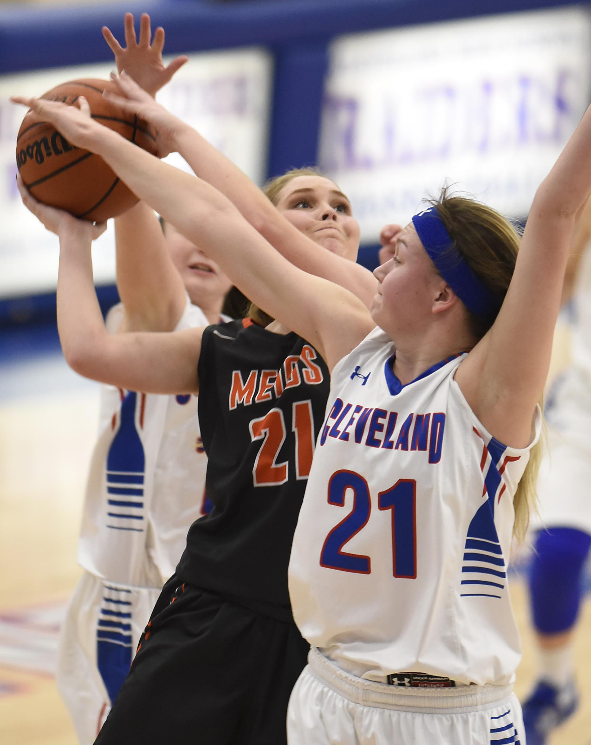 Meigs County's Kaylie Moore (21) puts up a shot and is fouled by Cleveland's Emma Flowers (21). The Meigs County Lady Tigers visited the Cleveland Lady Raiders in TSSAA girls basketball action during the Cleveland Holiday Tournament held on Friday December 30, 2016.