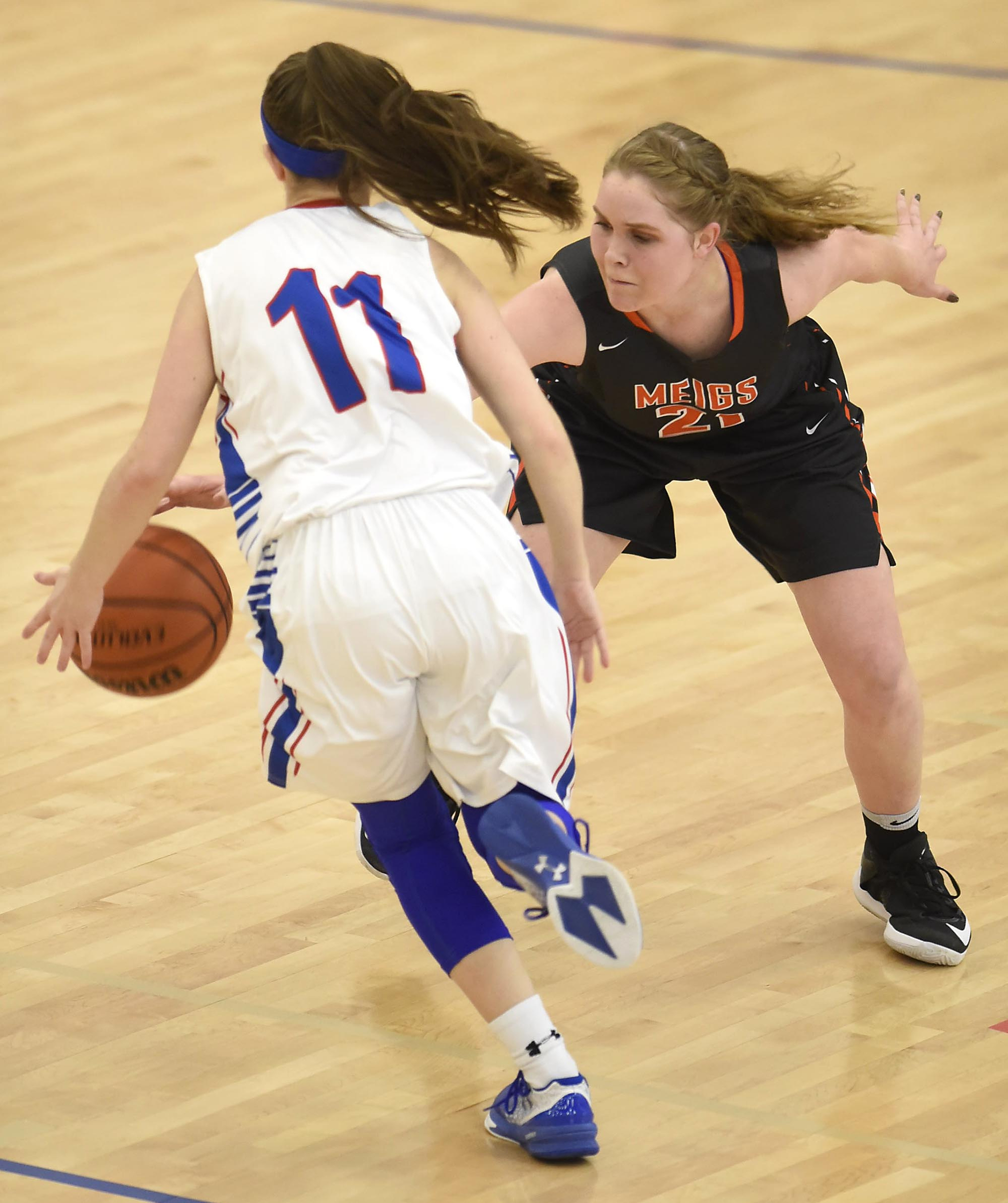 Meigs County's Kaylie Moore (21) steals the ball from Cleveland's Braylee Franklin (11). The Meigs County Lady Tigers visited the Cleveland Lady Raiders in TSSAA girls basketball action during the Cleveland Holiday Tournament held on Friday December 30, 2016.