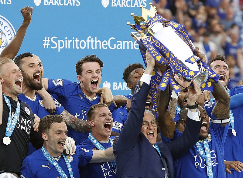 
              FILE - In this May 7, 2016, file photo, Leicester manager Claudio Ranieri and Leicester's Wes Morgan lift the trophy as Leicester City celebrate becoming the English Premier League soccer champions at King Power stadium in Leicester, England. (AP Photo/Matt Dunham, File)
            