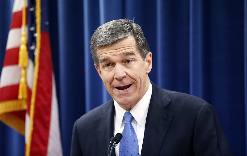  In this Dec. 15, 2016 file photo, North Carolina's Governor-elect Roy Cooper holds a press conference to criticize efforts by Republicans to cut the power of the governor's office during the special session of the General Assembly that is going on a few blocks away in Raleigh, N.C. North Carolina's incoming Democratic governor has sued over a new law passed by Republican legislators to limit his powers as he prepares to take office. Cooper filed the lawsuit Friday, Dec. 30 over the law that ends the control governors exert over statewide and county election boards. (Chris Seward /The News & Observer via AP, File)