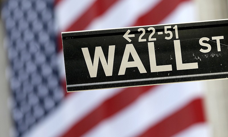 
              FILE - In this Sept. 8, 2015, file photo, a Wall Street street sign is framed by an American flag hanging on the facade of the New York Stock Exchange. U.S. stocks edged higher Friday morning, Dec. 30, 2016, on the final day of trading for the year. High-dividend stocks like phone companies and utilities fell the most, giving back some of the gains from a day earlier. Real estate stocks led the gainers. Trading was quiet ahead of the New Year's Day holiday. (AP Photo/Mary Altaffer, File)
            