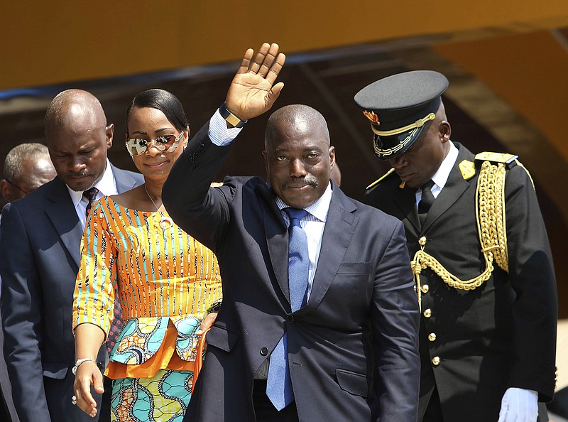 
              FILE- In this Thursday, June 30, 2016 file photo, Congolese President Joseph Kabila, center, waves as he and others celebrate independence for the Democratic Republic of Congo in Kindu, Congo. On Saturday, Dec. 31, 2016, political parties signed a deal that calls for Kabila to leave power after an election that now will be held by the end of next year instead of mid-2018 as his party originally proposed. (AP Photo/John Bompengo, File)
            