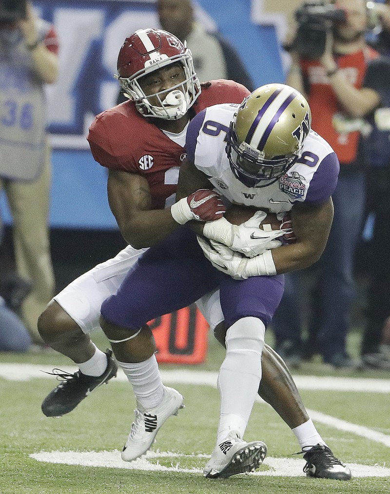 Alabama defensive back Hootie Jones (6) tackles Washington wide receiver Chico McClatcher (6) during the first half of the Peach Bowl NCAA college football playoff game, Saturday, Dec. 31, 2016, in Atlanta. (AP Photo/David Goldman)