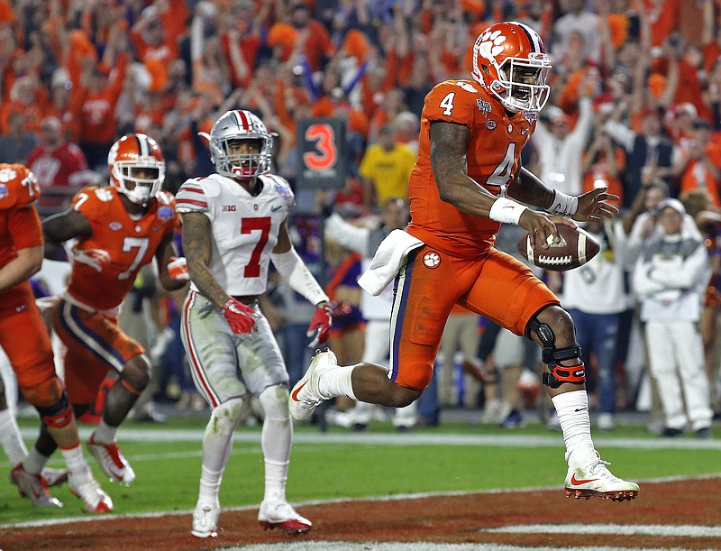 
              Clemson quarterback Deshaun Watson (4) runs in for a touchdown as Ohio State safety Damon Webb (7) watches during the second half of the Fiesta Bowl NCAA college football game, Saturday, Dec. 31, 2016, in Glendale, Ariz. (AP Photo/Ross D. Franklin)
            