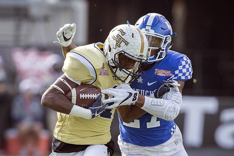 Georgia Tech running back Qua Searcy (1) is tackled by Kentucky safety Mike Edwards (27) after a gain during the first half of the TaxSlayer Bowl NCAA college football game, Saturday, Dec. 31, 2016, in Jacksonville, Fla. (AP Photo/Stephen B. Morton)

