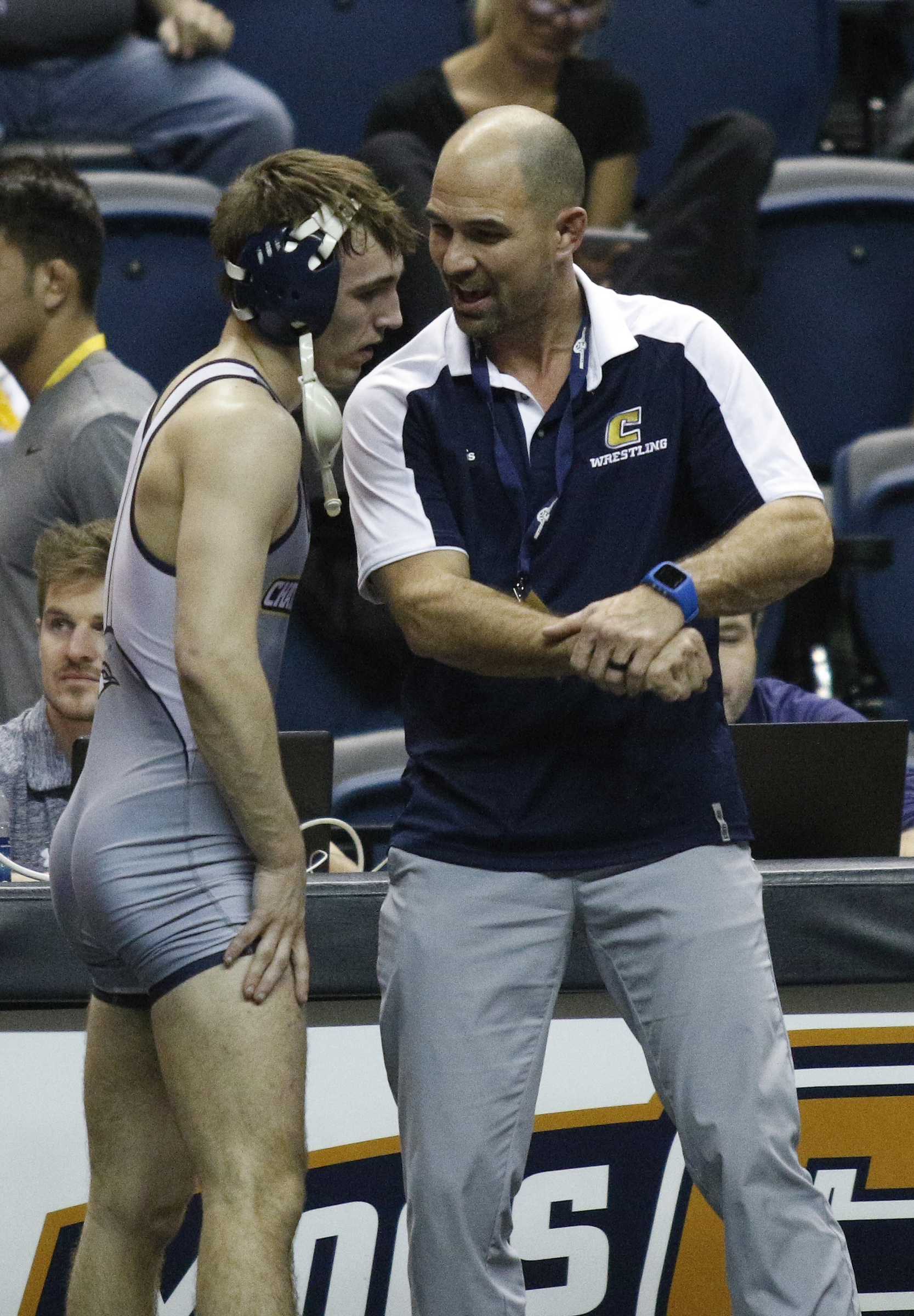 Chattanooga wrestling coach Heath Eslinger talks with Chattanooga wrestler Jake Huffine after his round of 16 losers bracket bout of the Southern Scuffle wrestling tournament at McKenzie Arena on Sunday, Jan. 1, 2016, in Chattanooga, Tenn.