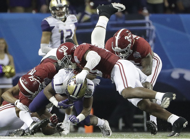 After Alabama defenders, from left, Dalvin Tomlinson, Reuben Foster and Tony Brown helped hold receiver John Ross and the Washington Huskies to 194 total yards during Saturday's 24-7 win in the Peach Bowl, the Crimson Tide must now refocus for next Monday's national championship game against Clemson in Tampa, Fla.