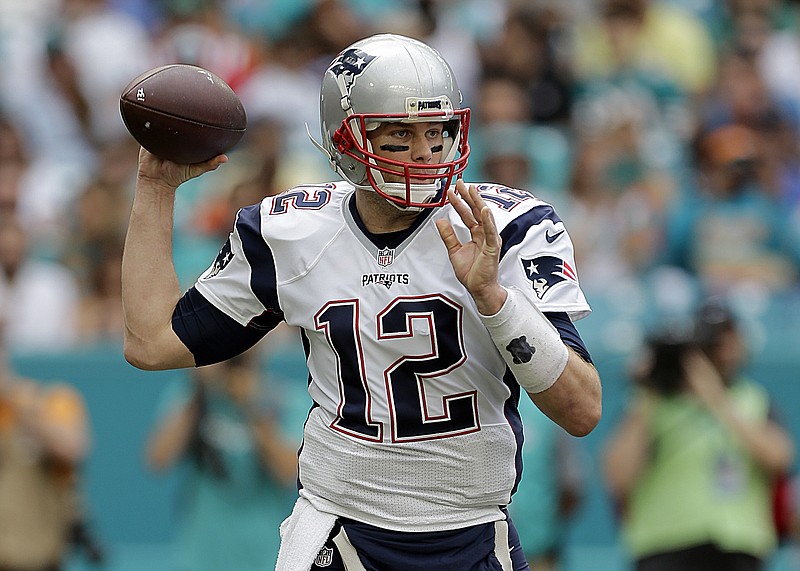 
              New England Patriots quarterback Tom Brady (12) looks to pass, during the first half of an NFL football game against the Miami Dolphins, Sunday, Jan. 1, 2017, in Miami Gardens, Fla. (AP Photo/Alan Diaz)
            