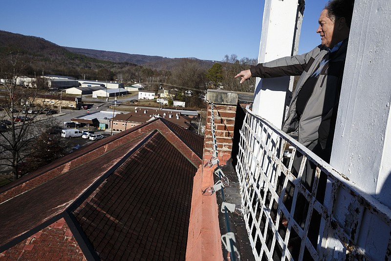 Historian Tom Davis looks over the roof of the Rhea County Courthouse from the belltower on Thursday, Dec. 29, 2016, in Dayton, Tenn. Tennessee Rep. Ron Travis is hoping to secure $200,000 in funds from the state for a new roof for the aging historic landmark which was the site of the 1925 Scopes trial.