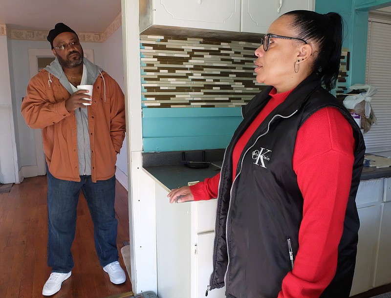 Robert Lee Jackson, Jr., left, and Renee Jackson stand in their empty house on 13th Avenue and talk about losing their son back in April. The parents of Robert Jackson have been trying to sell the property for months.