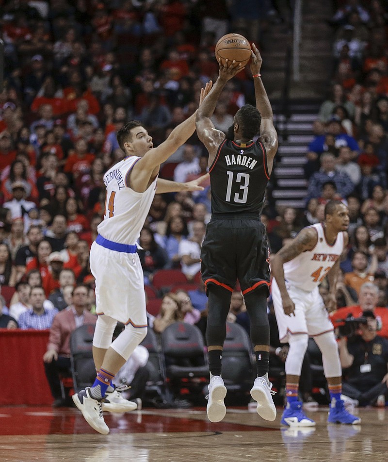 
              Houston Rockets guard James Harden (13) shoots over New York Knicks center Willy Hernangomez (14) during the first half of an NBA basketball game Saturday, Dec. 31, 2016, in Houston. (AP Photo/Bob Levey)
            