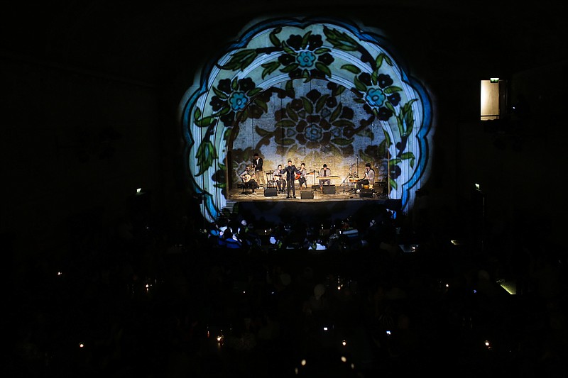 
              In this Dec. 18, 2016 picture, Musiqana, a Syrian band based in Berlin, perform during a concert marking their record release at the former silent movie cinema Delphi in Berlin. Musiqana draw both German and Syrian people to their concert of traditional Arab music, although the band admit it is difficult to perform while the humanitarian disaster in Aleppo continues to unfold. (AP Photo/Markus Schreiber)
            