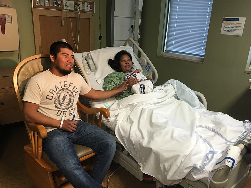 Proud parents Mabdial Escalante, left, and Catarina Orozco show off their daughter, Kathy Pedro Orozco, on Sunday at Erlanger hospital.