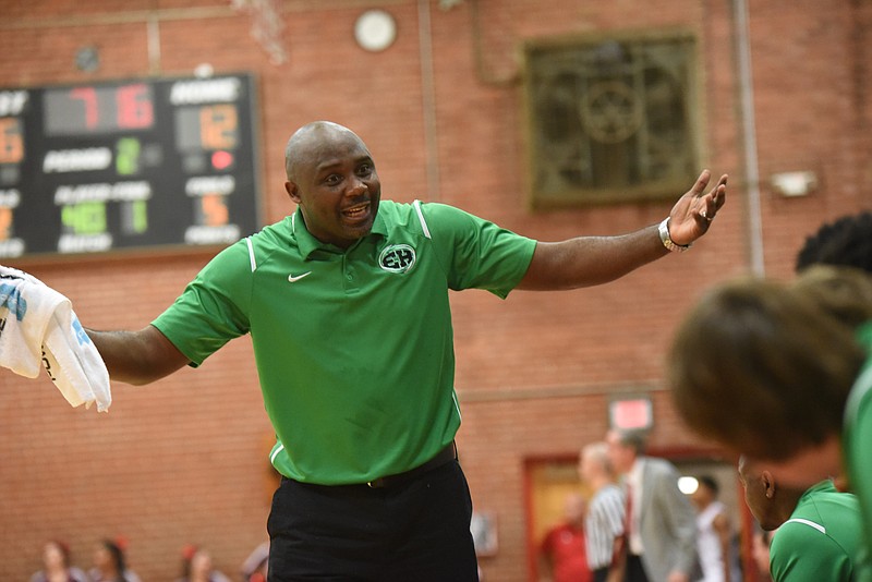 East Hamilton head coach Rodney English talks to his  Hurricanes on the bench at Baylor Tuesday night.