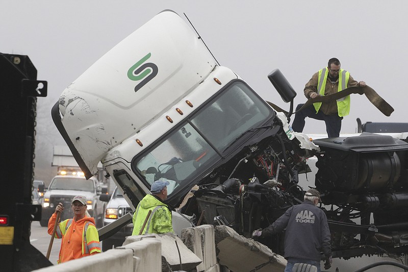 Emergency, TDOT and wrecker personnel clean up after a tractor trailer jackknifed near mile marker 8 on Interstate 75 northbound, blocking all but one land of traffic on Monday, Jan. 2, 2017.