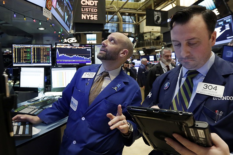 
              Specialist Meric Greenbaum, left, works at his post on the floor of the New York Stock Exchange, Tuesday, Jan. 3, 2017. The stock market opened the year on a strong note, led by big gains in banks and energy companies. (AP Photo/Richard Drew))
            