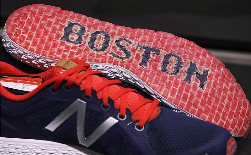 
              In this Wednesday, Dec. 28, 2016 photograph, the word "Boston" accents the sole of the New Balance Zante v2 shoe on display at the storefront of the world headquarters of New Balance in the Brighton neighborhood of Boston. Some of America's top sneaker makers are racing to the Boston area. Reebok picked the city's Seaport District for its new global headquarters in December. Homegrown Boston-area companies New Balance and Converse opened new offices in 2015. Industry watchers said the boldly designed headquarters are partly a bid to lure millennial talent. (AP Photo/Charles Krupa)
            