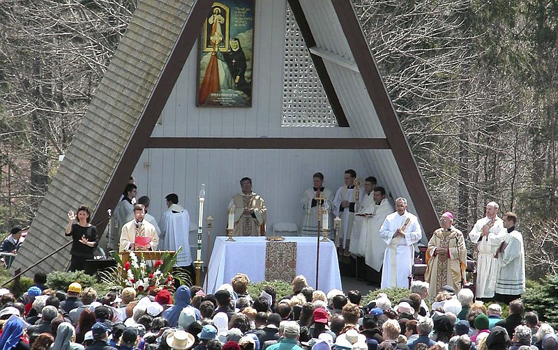 
              FILE- In this April 27, 2003, file photo, people attend the Mass officiated by Bishop Thomas L. Dupre, third from right, at the National Shrine of The Divine Mercy in Stockbridge, Mass. Dupre, the first Roman Catholic bishop in the United States to be indicted on a sexual-abuse claim during a flood of abuse accusations against church officials, died Friday, Dec. 30, 2016, according to the Diocese of Springfield. Dupre was 83. (AP Photo/Alan Solomon, File)
            