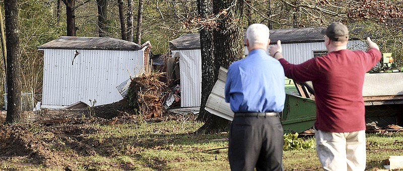 Patrick Davenport, left, and neighbor J.P. Kelley look over the scene of Monday's deadly tornado that claimed the lives of multiple people in Rehobeth, Ala., Tuesday, Jan. 3, 2017. (Danny Tindell/Dothan Eagle via AP)
