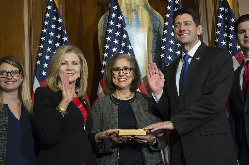 House Speaker Paul Ryan of Wis. administers the House oath of office to Rep. Marsha Blackburn, R-Tenn., during a mock swearing in ceremony on Capitol Hill in Washington, Tuesday, Jan. 3, 2017. (AP Photo/Zach Gibson)